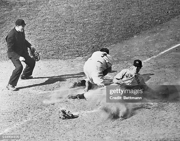 Cincinnati, Ohio: New York Yankees became World Champions once again when they defeated the Cincinnati Reds 7-4. Here, Joe DiMaggio is safe at home...