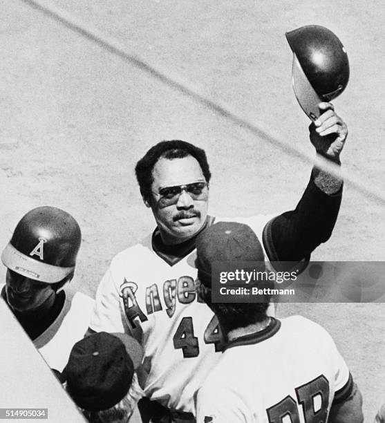 Anaheim, CA: California Angels' designated hitter Reggie Jackson raises his helmet to the fans after he hit a 2-run homer in the fourth inning to...