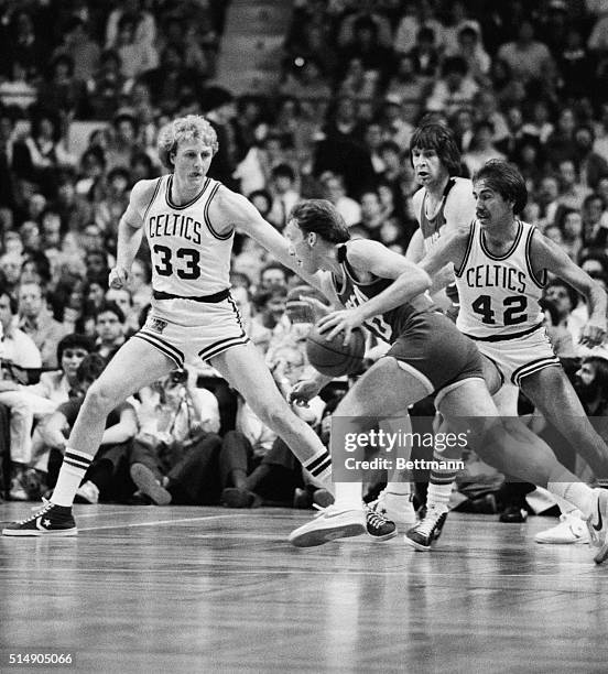 Boston,MA: Rockets' Mike Dunleavy drives past Celtics' Larry Bird and Chris Ford, 1st quarter, 2nd game, NBA Campionship Boston Garden. Rockets'...