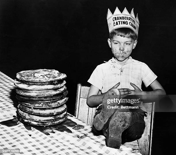 Six-year-old Richard Baranski caresses a full belly after being crowned Cranberry Pie Eating Champion, upon eating a 10-inch cranberry pie in 15...