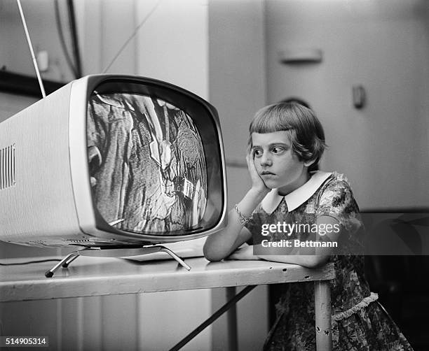 Nine-year-old Rosemary Muller of Roslyn Heights, Long Island, recovering from a heart operation, watches a similar operation being performed on...