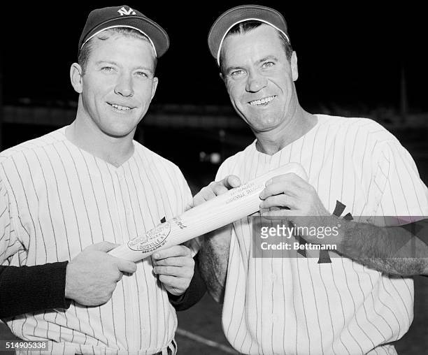 New York, NY: Yankee slugging star Mickey Mantle, left, and Hank Bauer are shown in a pre-game pose with the bat made to Bauer's specifications....