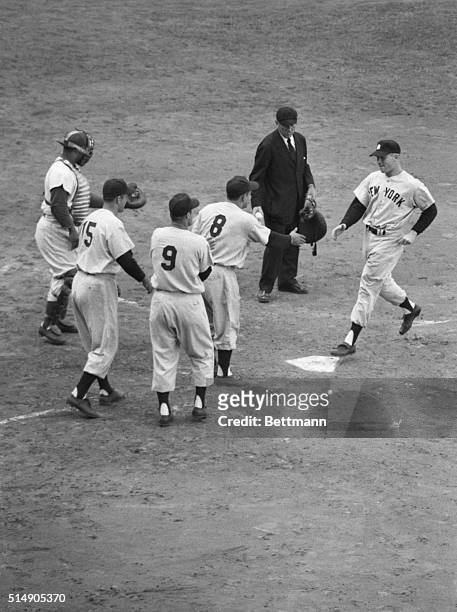 Brooklun, NY: After hitting the fourth grand slam homer in Series history, Yankee Mickey Mantle crosses home plate in the third inning of the fifth...