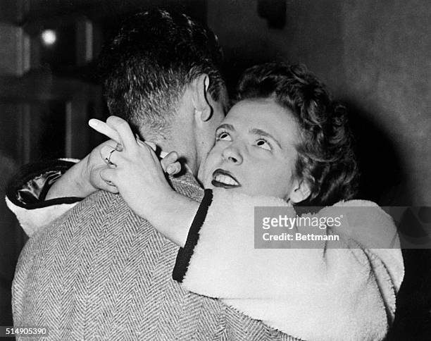 Clara Marr hugs her boyfriend, Warren MacQuarrie, with her fingers crossed for luck as he is shipped out to Chapel Hill, South Carolina for war.