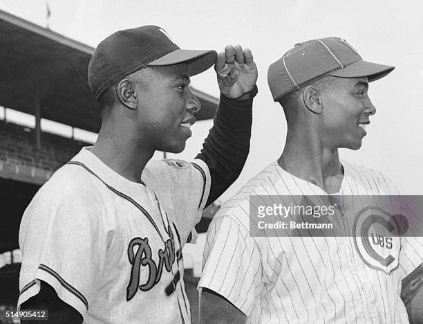 Chicago, IL: Hank Aaron of the Braves and Ernie Banks of the Cubs look out to right field in Wrigley Field here where Banks clouts most of his...