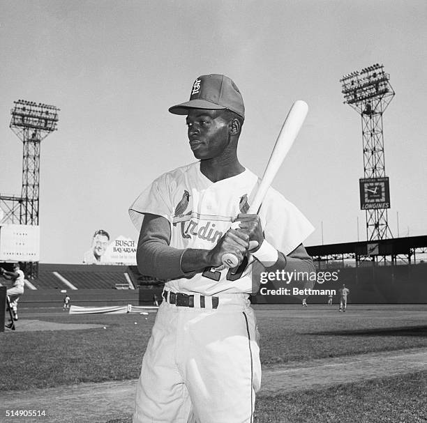 Portrait of St. Louis Cardinals' outfielder Lou Brock posing with bat.