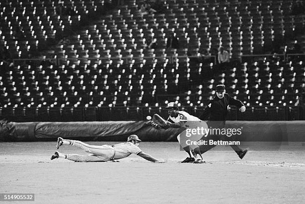 Atlanta, Georgia: St. Louis shortstop, Ed Crosby, dives back into first and is safe as Atlanta's Hank Aaron takes the throw from the pitcher. The...