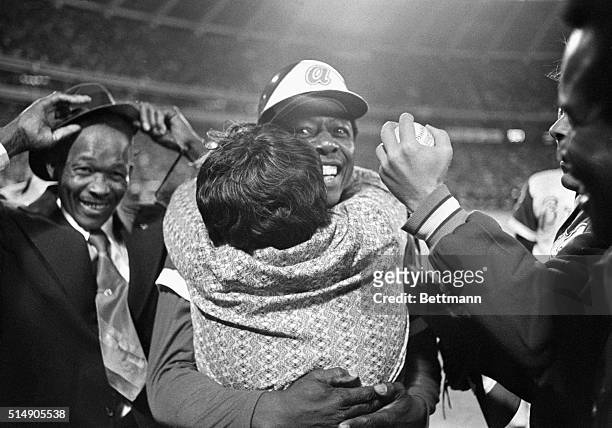 Atlanta, Georgia: Hank Aaron's mother, Estella, gives her favorite home hitter a hug after Hammerin' Hank made Babe Ruth an also-ran. Catching a...