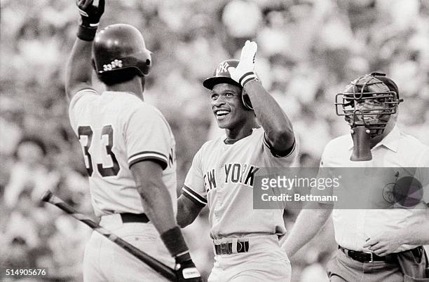 Arlington, TX: New York Yankee Ricky Henderson wears his ear-to-ear smile after hitting a lead off homer off of Texas Ranger pitcher Glen Cook in the...