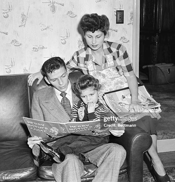 Frank and Nancy Sinatra read with their daughter, also named Nancy. The young Nancy later made a name for herself with the song "These Boots Are Made...