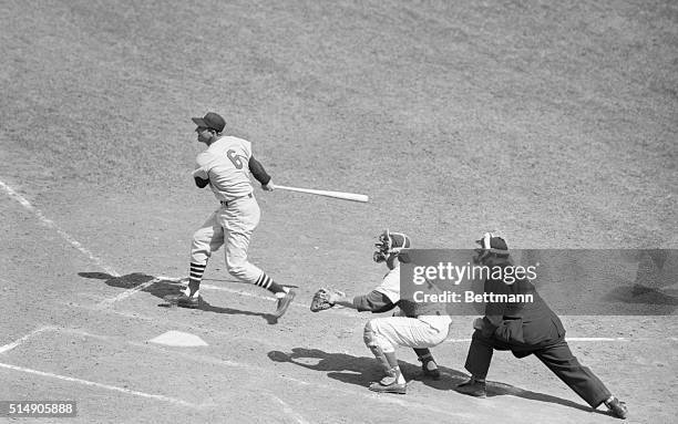 Chicago, IL- St. Louis Slugger Stan Musial follows through after crashing a pinch-hit double for his 3,000th Major League hit in the game against...