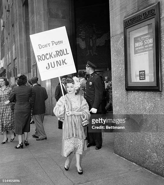 New York, NY- : Red-haired Gloria Parker, 88-pound firebrand of the CBS annual stockholders meeting , parades in front of the RCA building with her...