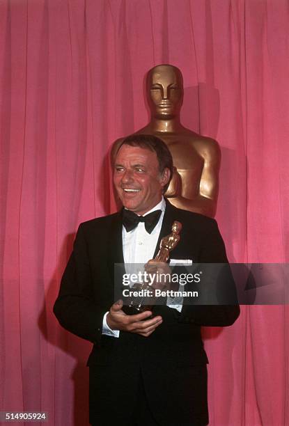 Los Angeles: Singer-actor Frank Sinatra holds Oscar he received for the Jean Hersholt Humanitarian Award for charitable activities at the Music...
