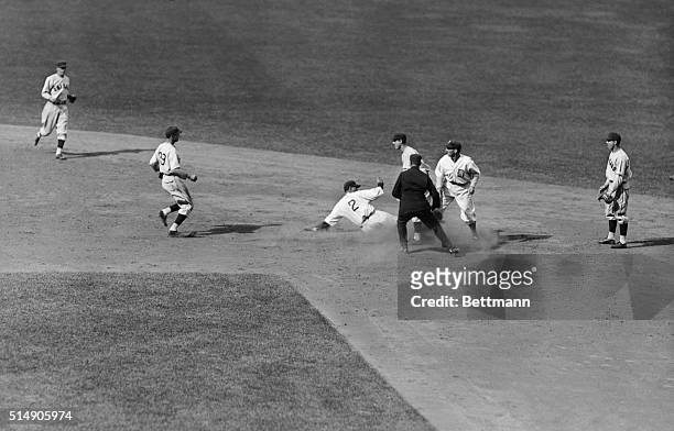 Detroit,MI- Gehringer of the Detroit Ttigers slides safely back to second base after being chased in rundown on Goslin's hit to French. Goslin, is...