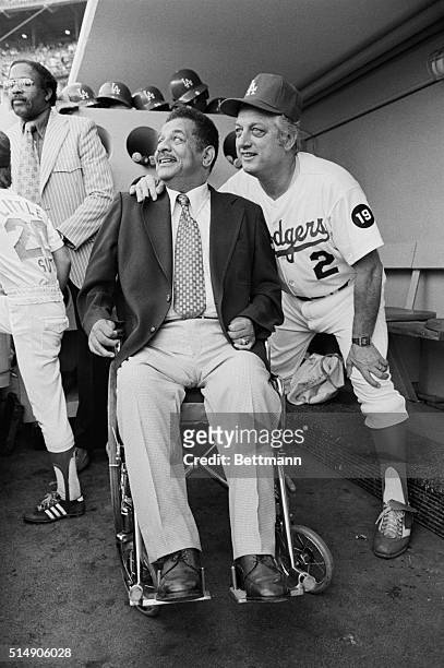 Los Angeles, CA: Former Dodger catcher Roy Campanella watches the opening game of the 1978 World Series from the Dodger dugout. Tommy Lasorda stands...