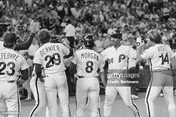 Philadelphia, PA: Phils' Tony Perez is congratulated by teammates Joe Morgan and Pete Rose at home plate after he hit a three-run homer to win the...