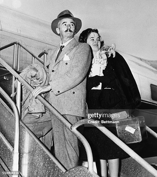 Memphis, Tennessee: Author William Faulkner of Oxford, Mississippi, is pictured with his daughter, Jill, age 17, as they took off for New York in...