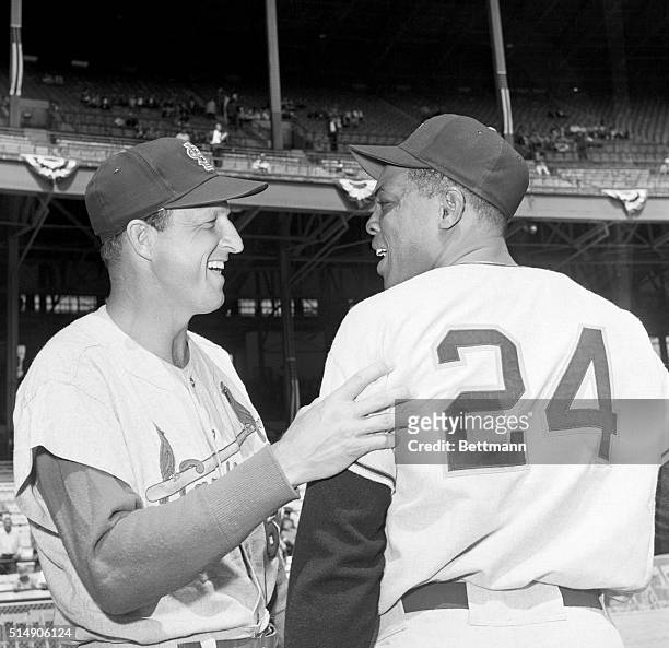 Cleveland, OH- Willie Mays of the New York Giants, a comparative youngster in baseball, is greeted by Stan Musial of the St. Louis Cardinals, who has...