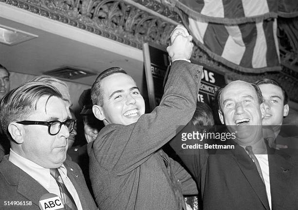 Chicago, IL: Despite a concession of the election to President Eisenhower, Borden Stevenson holds up his father's hand in the traditional symbol of...