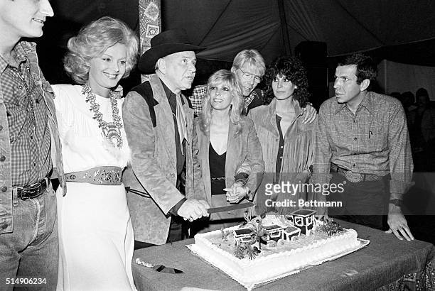 Rancho Mirage, CA- Frank Sinatra is surrounded by family members as he prepares to cut his own birthday cake during his 65th birthday party at the...