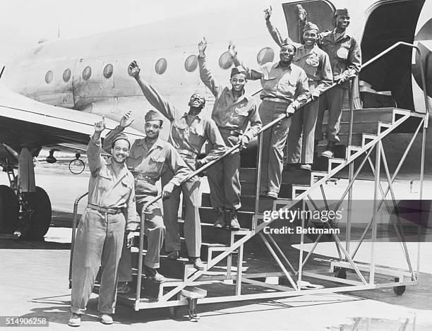 Seven New York and New Jersey servicemen from the 16 member 99th Pursuit Squadron arrive at La Guardia aboard a Trans-Atlantic ATC plane. The...