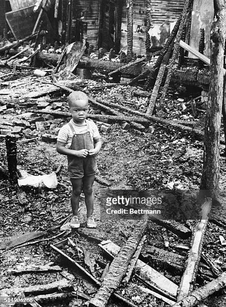 Detroit, MI- Three year old Thomas Allen stands the ruins of his home on Detroit's east side after it was burned to the ground in the riots that hit...