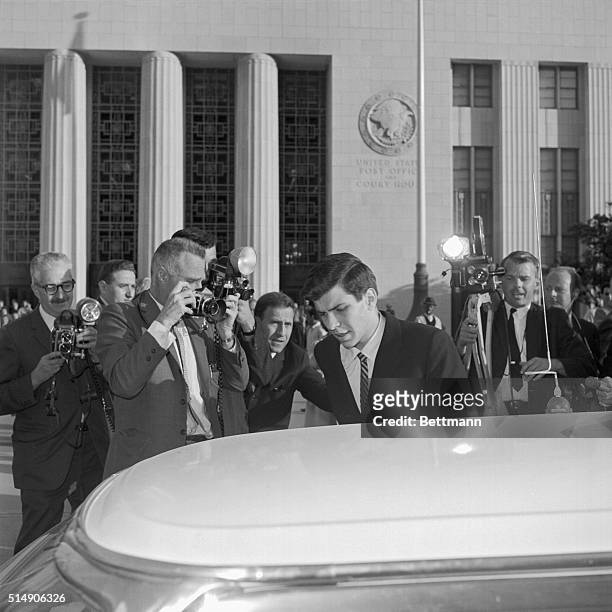 Los Angeles, CA: Frank Sinatra Jr., surrounded by newsmen and photographers, leaves the Los Angeles Federal Court Building 2/14 after an angry,...