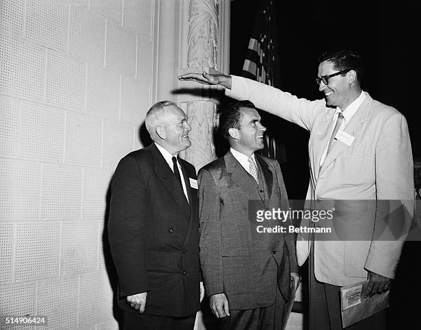 Annapolis, MD: Rogers "Rajah" Hornsby, baseball great, and Vice President Richard Nixon , who are no pigmies, are dwarfed by George Mikan, six-foot,...