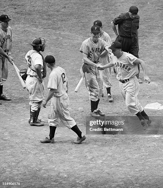 New York, NY- Ralph Kiner of the Pirates is congratulated by teammates as he scores on his game winning homer in the 9th inning of the game with the...