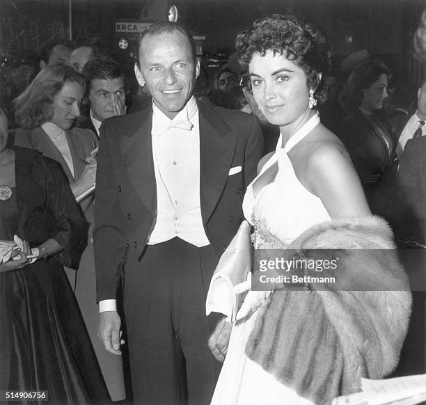 Hollywood: Frank Sinatra, nominated for best actor for his role in "The Man With the Golden Arm," arrives with Peggy Connelly at the 28th Annual...