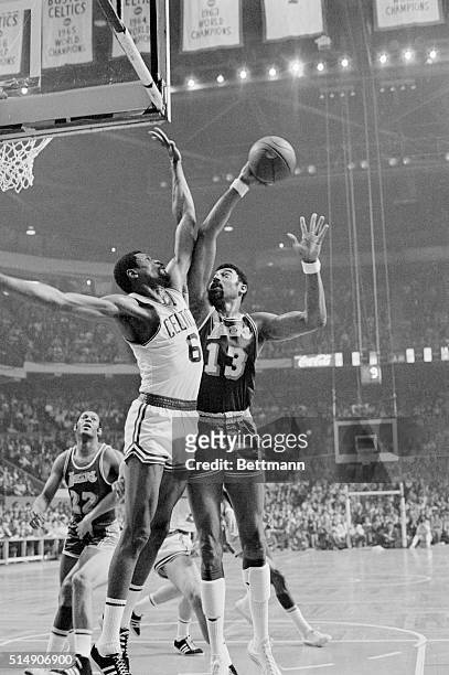 Boston, Massachusetts: In the Lakers-Celtics match, Wilt Chamberlain , of the Los Angeles Lakers challenges Bill Russell of the Boston Celtics as he...