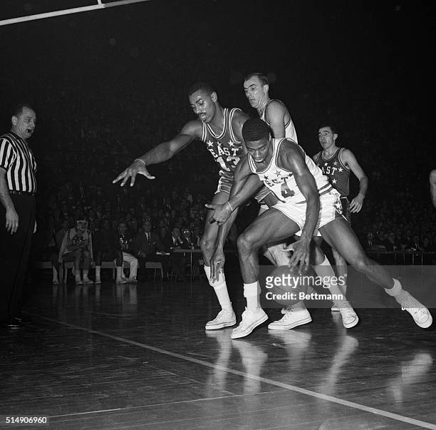 St. Louis, MO- Oscar Robertson , Cincinnati, does some pretty fancy dribbling trying to get around Wilt Chamberlain, Phil 76er, during the 3rd...