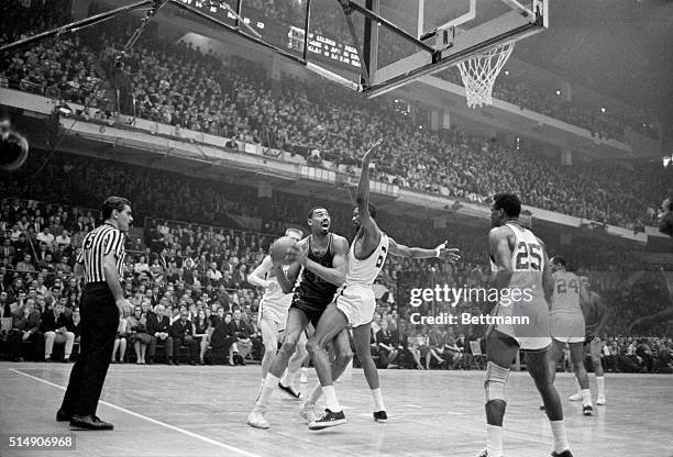 Boston, MA- 76ers-Celtics, Celtics' Bill Russell checks 76ers' Wilt Chamberlain as he tries to move in under the basket, 2nd quarter action, 5th...