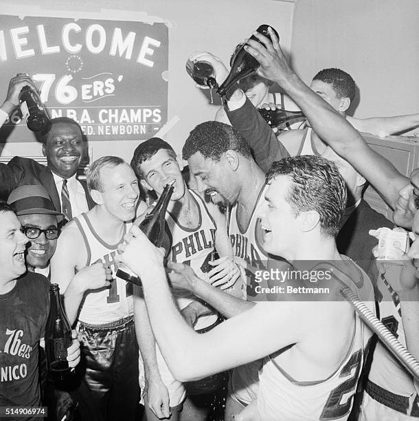Philadelphia, PA- After beating the Celtics 140-116, for the Eastern NBA title, members of the 76ers pour champagne over Wilt Chamberlain . In...