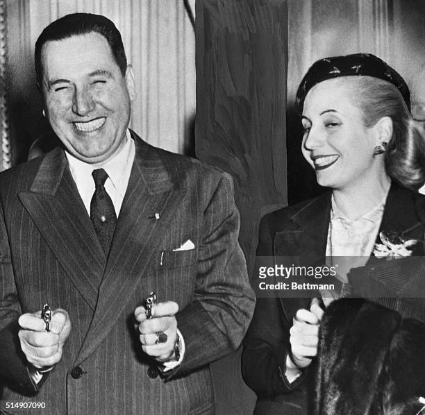 Buenos Aires, Argentina- President Juan Peron of Argentina is in a jovial mood as he demonstrated a pair of miniature cigarette lighters in the shape...