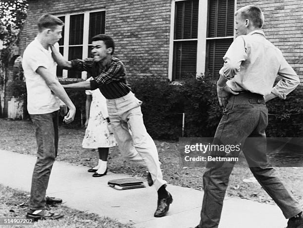 Johnny Gray punches a white student during a scuffle in Little Rock, Arkansas. Johnny and his sister, Mary , were en route to their segregated school...