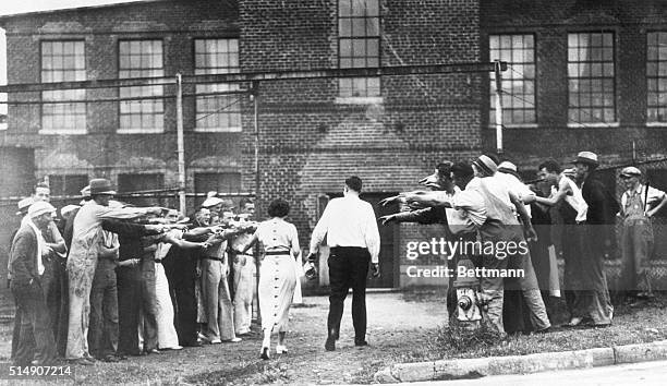 Concord, NC- Strikers picketing the Cannon Textile Mill jeer a pair of non-striking workers as they arrive at the mill for work.