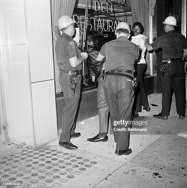 Newark, NJ- Police frisk two Negro rioters during the second night of violence in New Jersey's largest city. Firebomb-hurling Negroes rioted through...