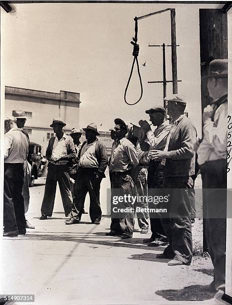 San Pedro, CA- Pickets near the Luckenback and Panama Pacific Steamship Lines docks on Terminal Island. A noose, a grim reminder of the hatred the...