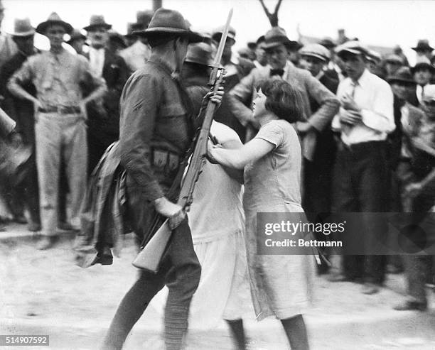 Gastonia, NC- Photo shows a group of girl textile strikers attempting to disarm a National Guard trooper who was ordered to the Loray Mills here in...