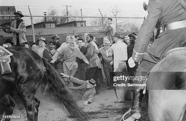 Cleveland, OH- Louis Eiben falls to the ground as mounted police push through massed picket lines to break up a strike demonstration outside the Park...