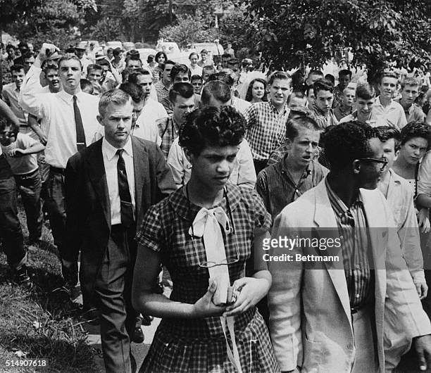 Charlotte, North Carolina: Dorothy Geraldine Counts, 15 is followed by a crowd of jeering teenagers as she leaves Harding high school with her...