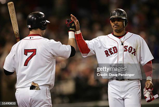 Orlando Cabrera of the Boston Red Sox celebrates with teammates Trot Nixon after scoring on a two-run single hit by David Ortiz in the fifth inning...