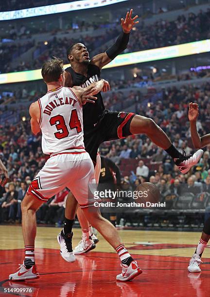 Joe Johnson of the Miami Heat looses control of the ball after being fouled by Mike Dunleavy of the Chicago Bulls at the United Center on March 11,...
