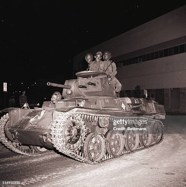 Santo Domingo, Dominican Republic-A Dominican government tank drives along Palo Hincado Street opposite Independence Park here Nov. 24. Leaders of...