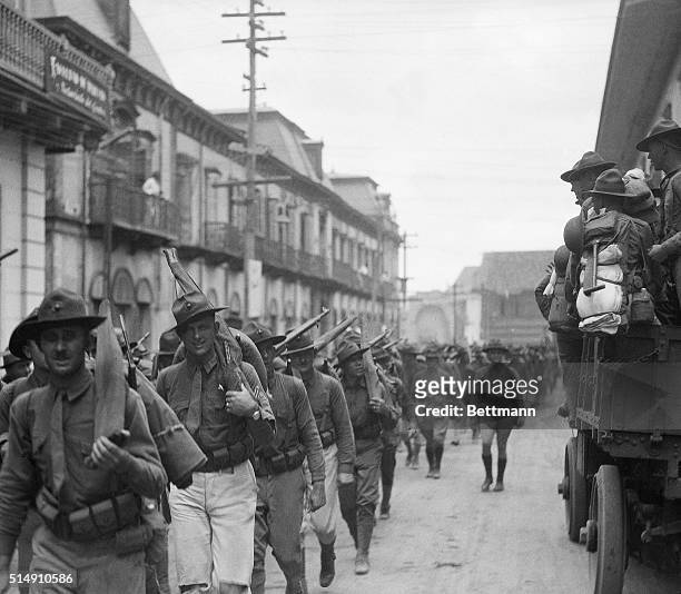 Managua, Nicaragua-A detachment of U.S. Marines marches through a Managua street, going on patrol duty. Scenes such as this are now being re-enacted...