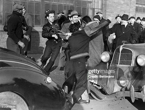 Dearborn, MI-Pickets outside the main gate of the Ford River Rouge Plant give this well-dressed young man his wish, as they gang up on him to "give...