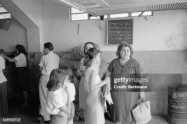 Havana, Cuba-With most food still rationed in Cuba, it is not unusual for lines to form awaiting delivery of produce. Here, these women and their...