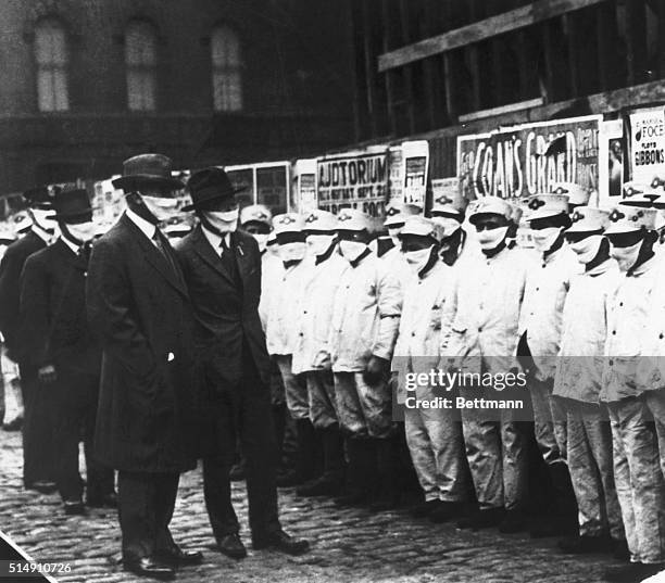 Chicago, Illinois- Inspecting Chicago street cleaners for Spanish influenza. Officials are wearing gauze masks.