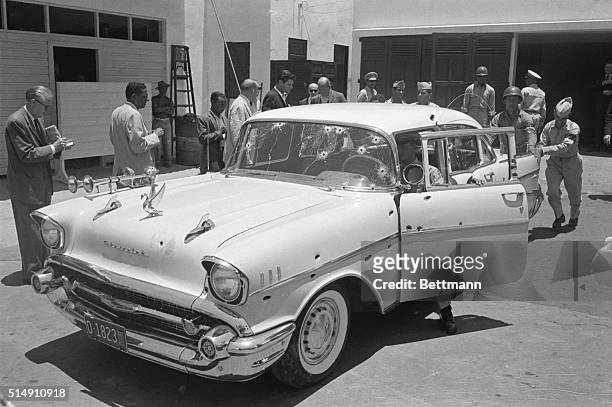 Ciudad Trujillo, Dominican Republic-Newsmen view the car in which Dominican dictator Rafael Trujillo was assasinated. The automobile contained about...